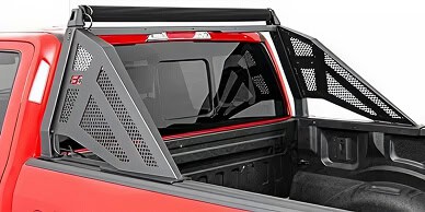 Red pickup truck with a black cargo bed and protective side panels.