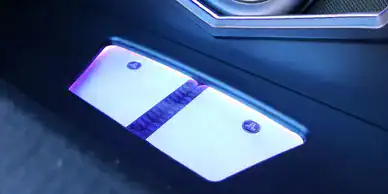 LED illuminated foot pedal on modern vehicle floor mat.