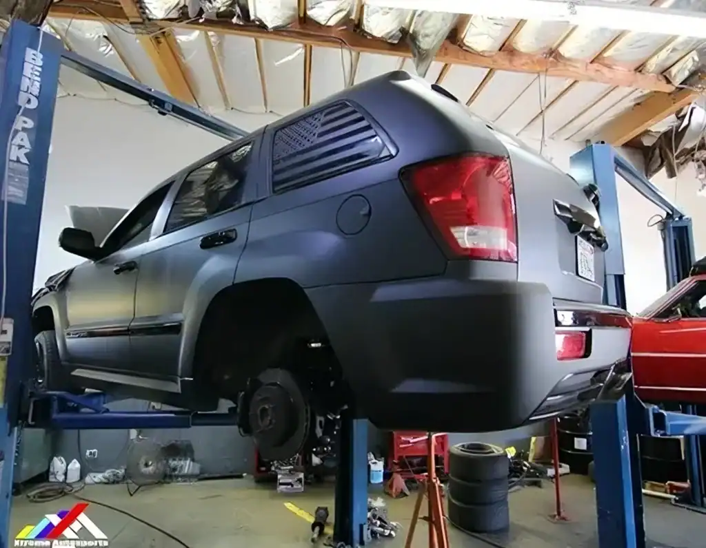 Wrench and car lift in auto repair shop for vehicle maintenance and repair.