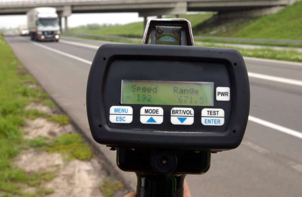 Police speed gun monitoring traffic